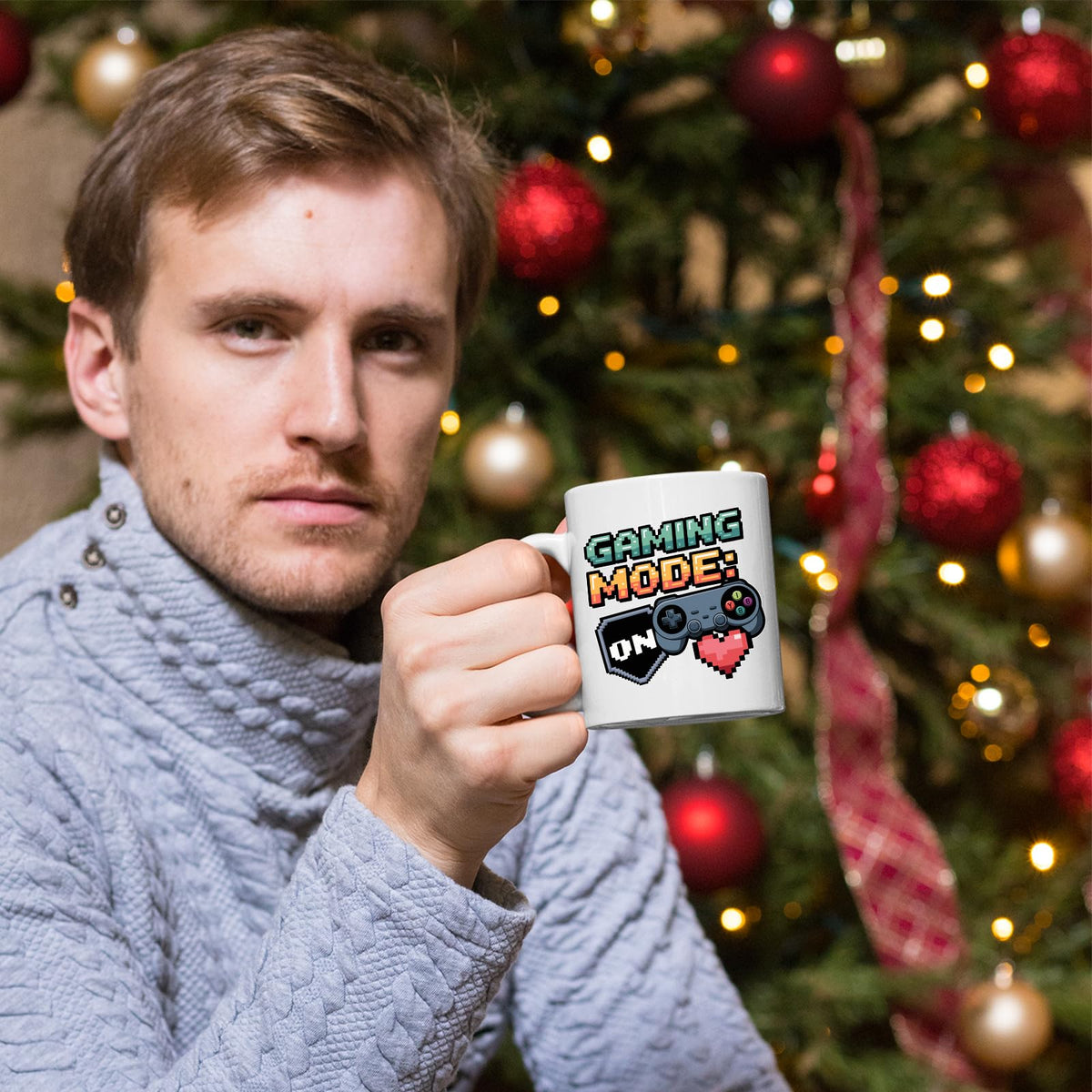 Man holding the Gaming Mode On mug by a Christmas tree