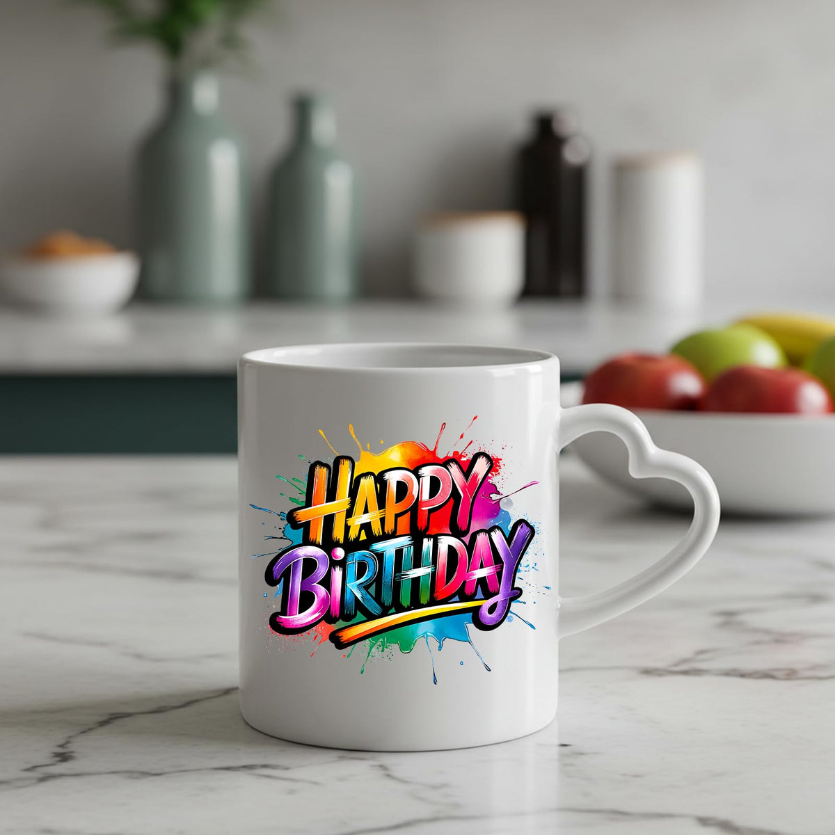 Happy Birthday rainbow splash heart-handle mug on a marble counter with fruit