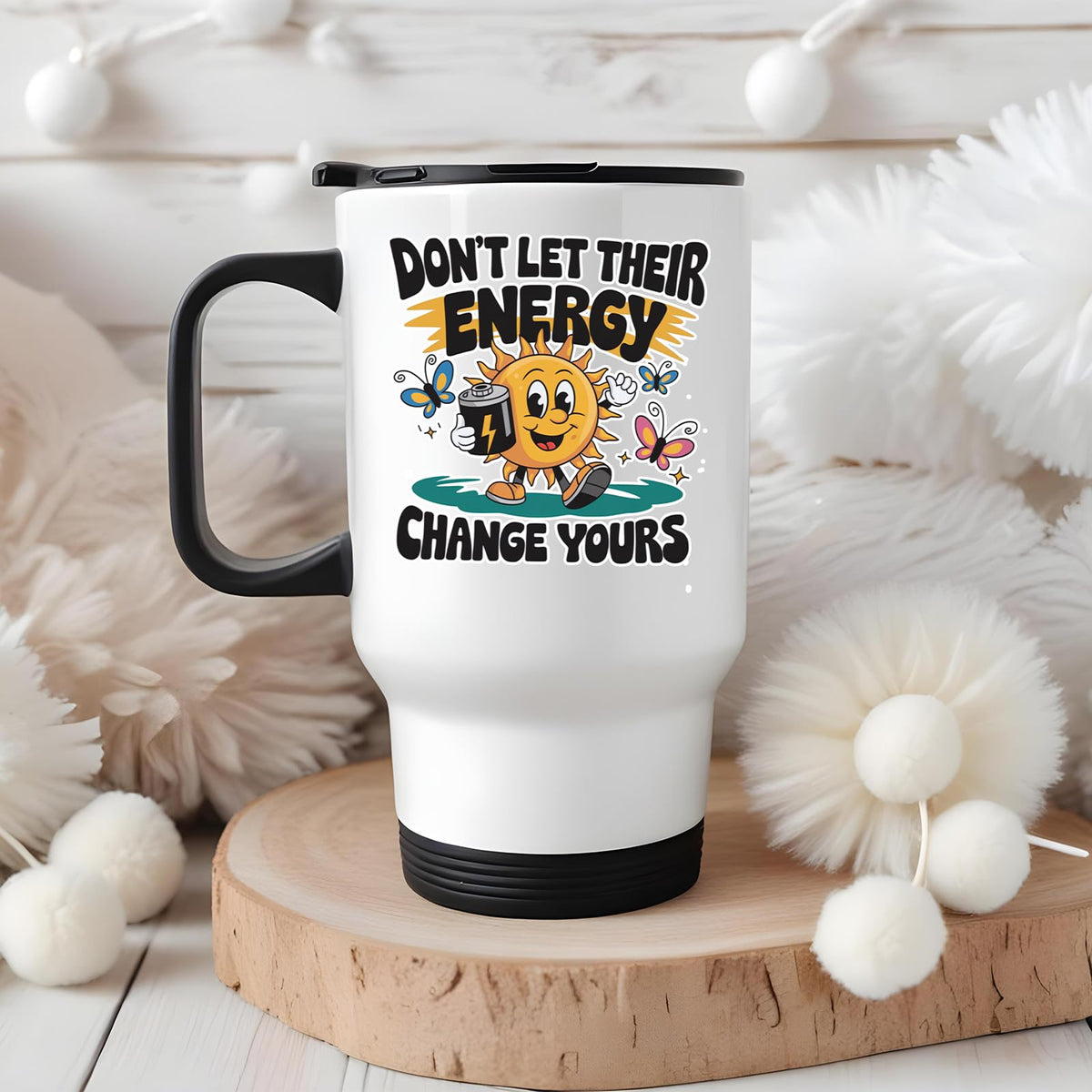 Positive Vibes sun travel mug on a wooden slice with white pom-poms