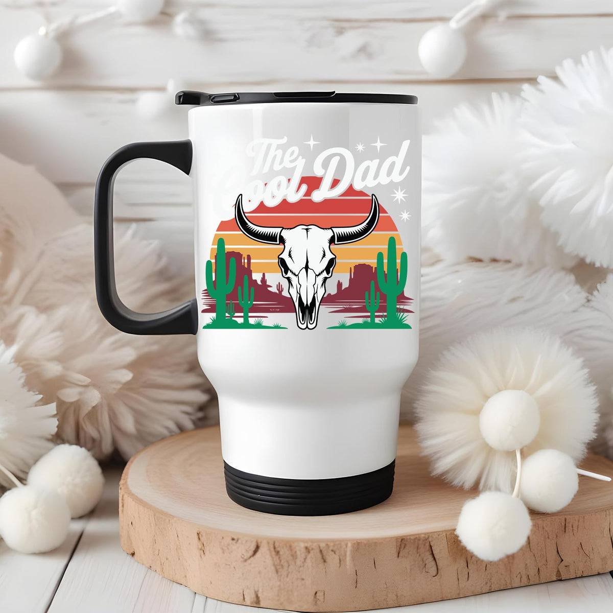 The Cool Dad bull skull travel mug on a wooden slice with white pom-poms