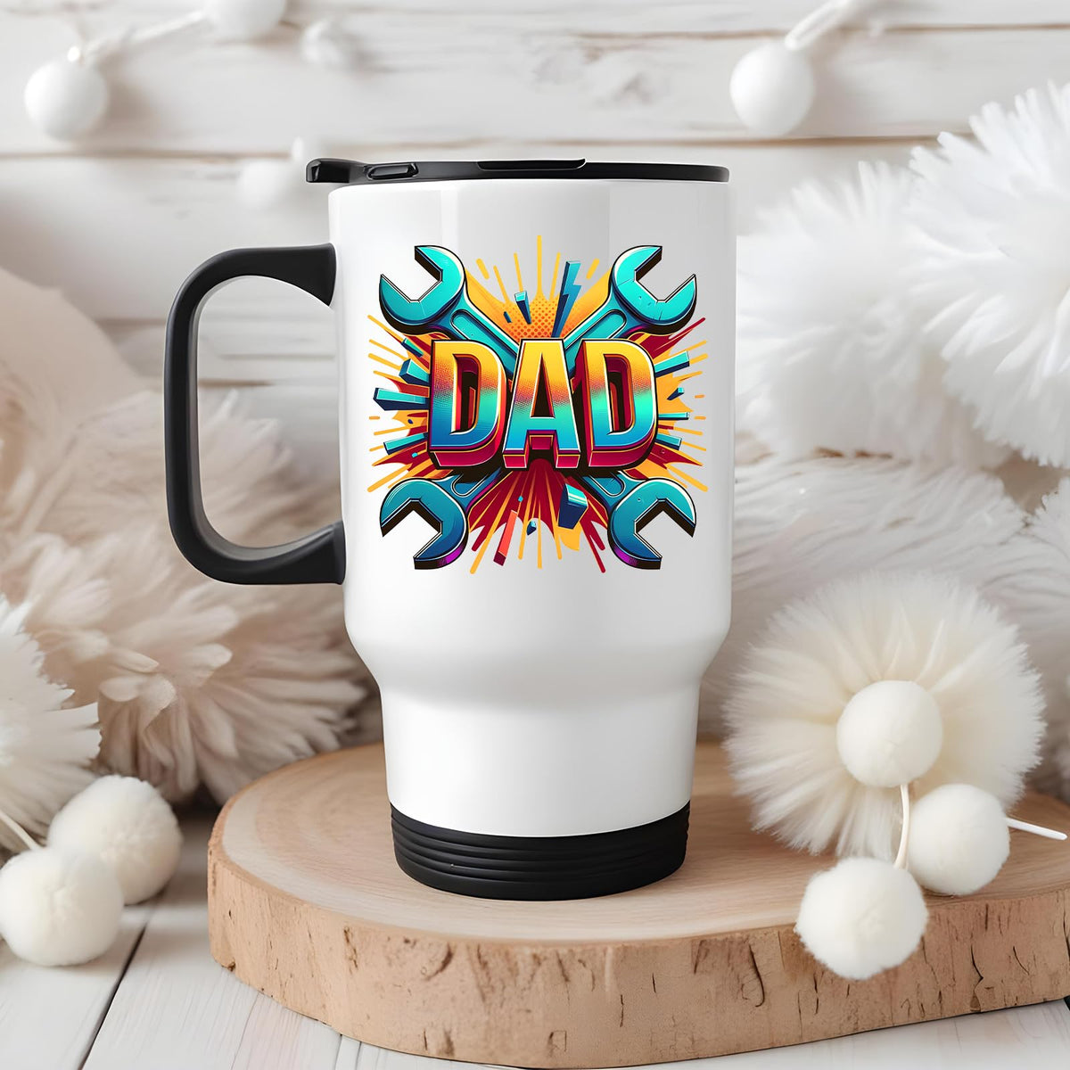 DAD spanners travel mug on a wooden slice with white pom-poms