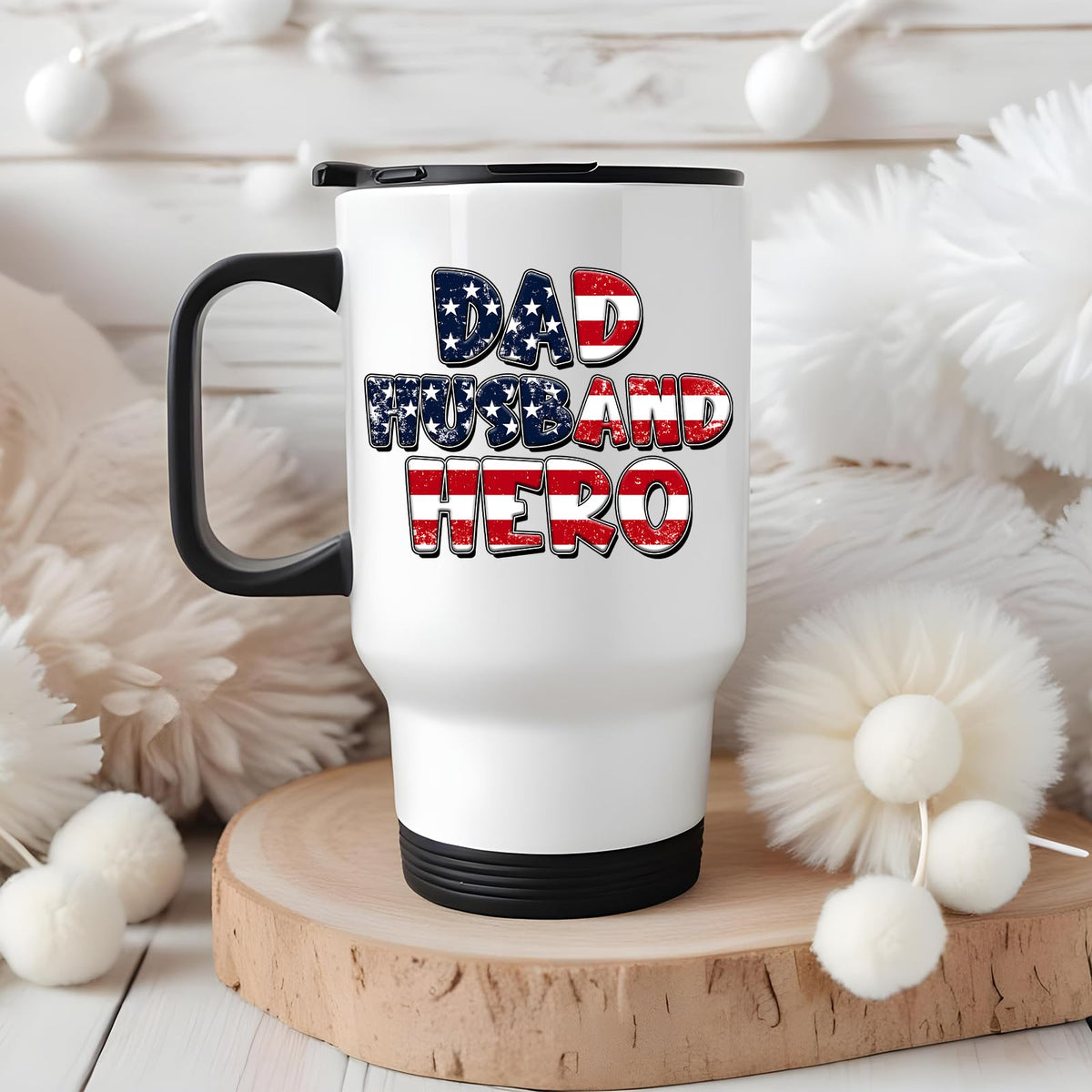 Dad Husband Hero travel mug on a wooden slice with white pom-poms