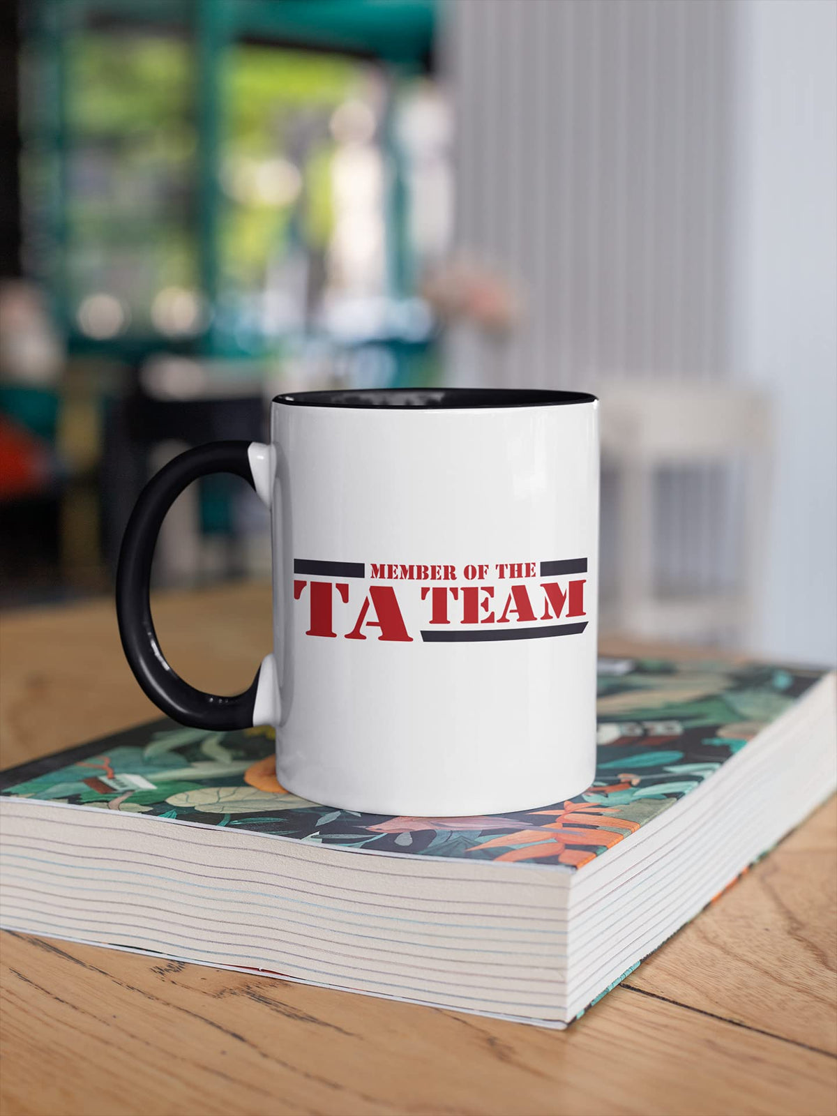 TA Team mug on a stack of books
