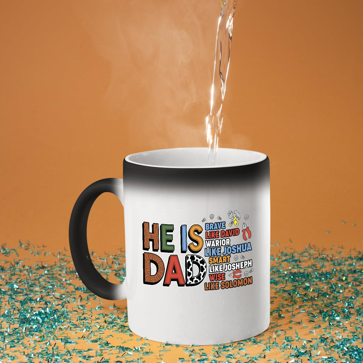 Hot water poured into the colour changing mug as the He Is Dad Bible verse design appears