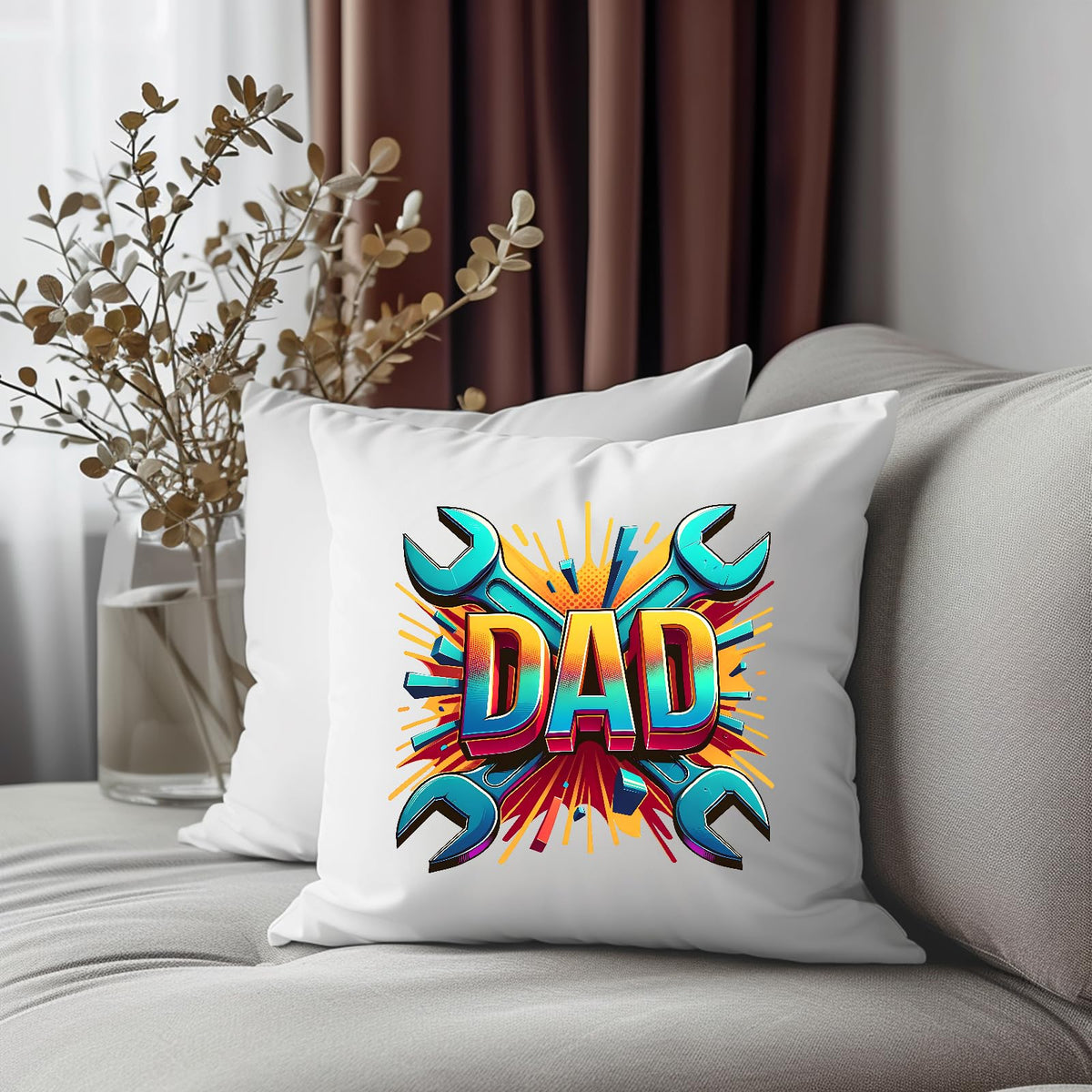 DAD spanners cushion on a grey sofa beside dried flowers