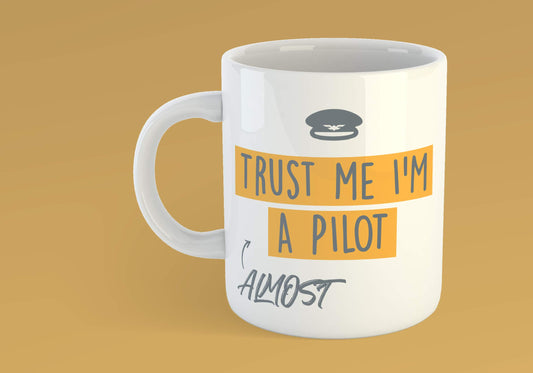 Trust Me I'm Almost A Pilot mug on an orange background