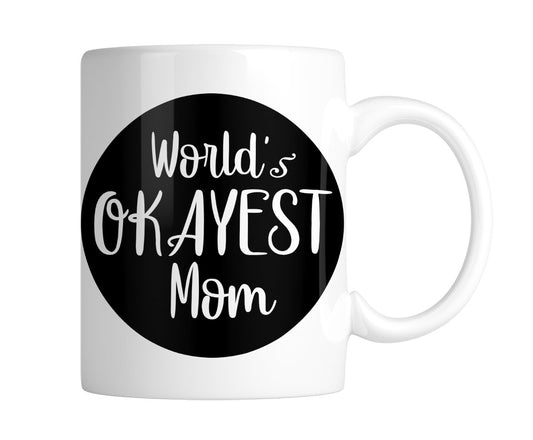 White mug with “World's Okayest Mom” in white on a black circle, handle on the right