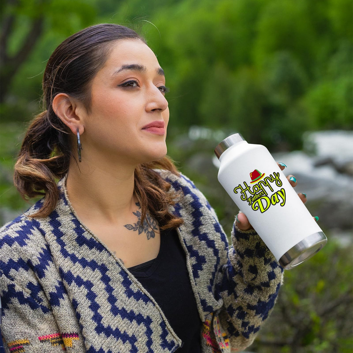 Woman holding the Father's Day bottle outdoors