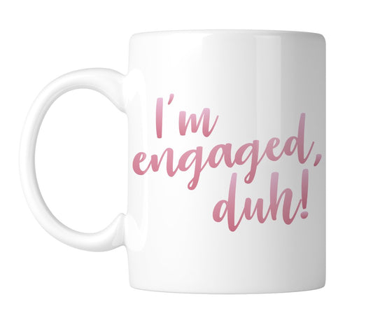 White mug with “I'm engaged, duh!” in pink script, handle on the left