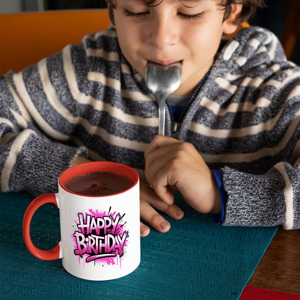 Child drinking from the mug with a red handle