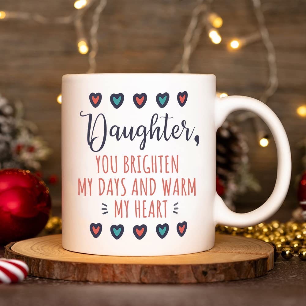 Daughter mug beside red baubles