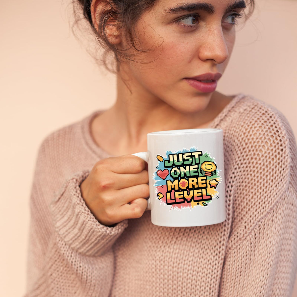 Woman sipping from the Just One More Level mug