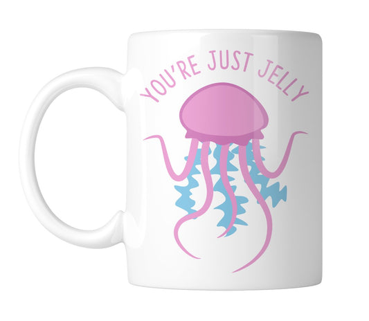 White mug with a pink jellyfish and “You're Just Jelly”, handle on the left