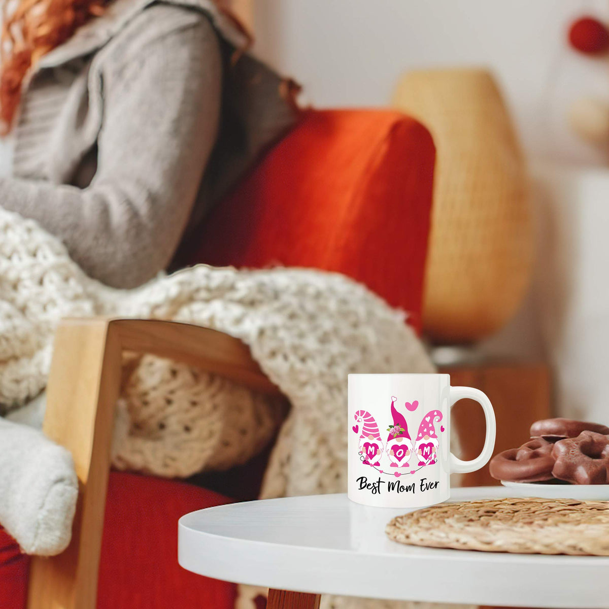 Best Mom Ever mug on a table by a red chair