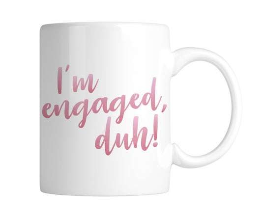 White mug with “I'm engaged, duh!” in pink script, handle on the right