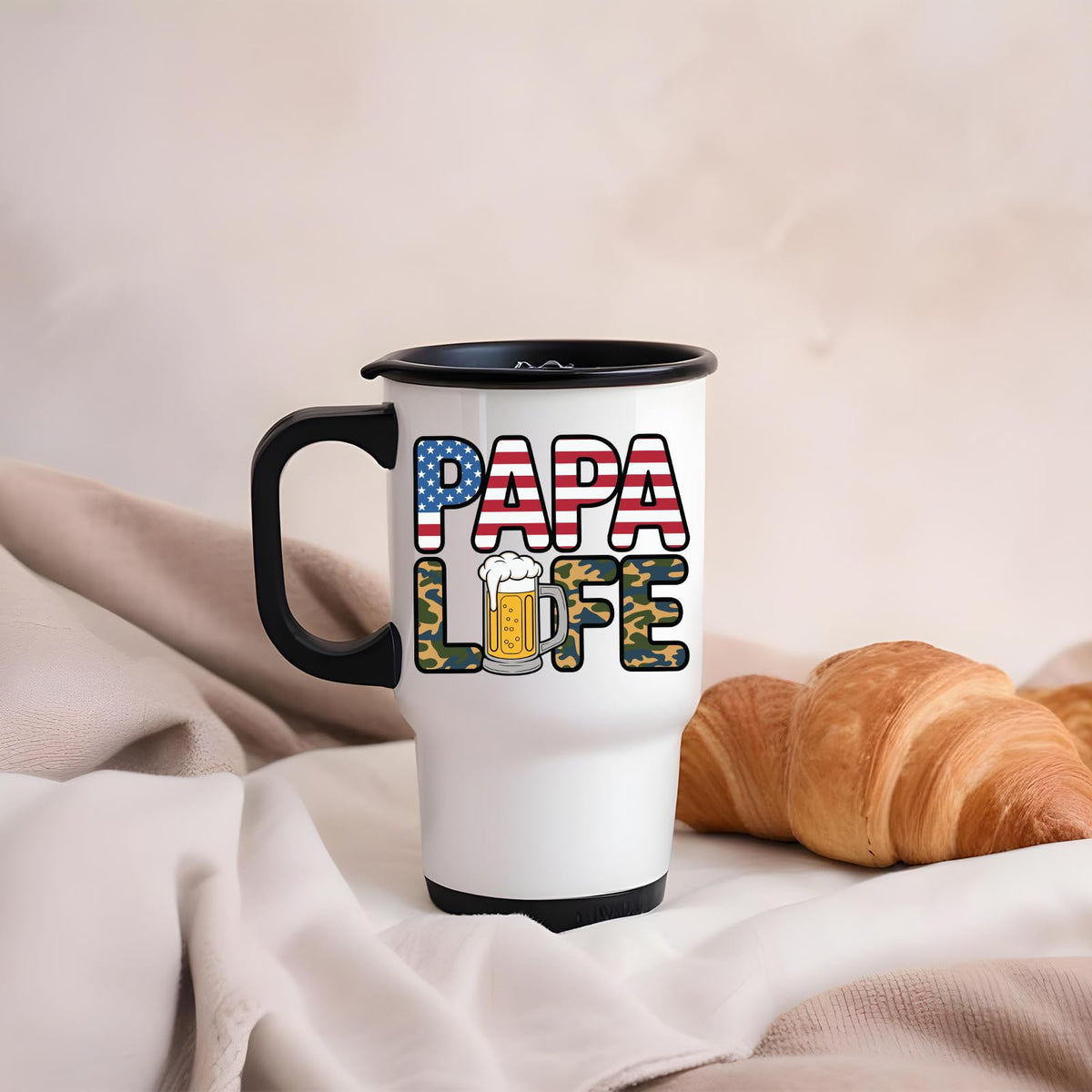 Papa Life travel mug on a soft blanket beside a croissant