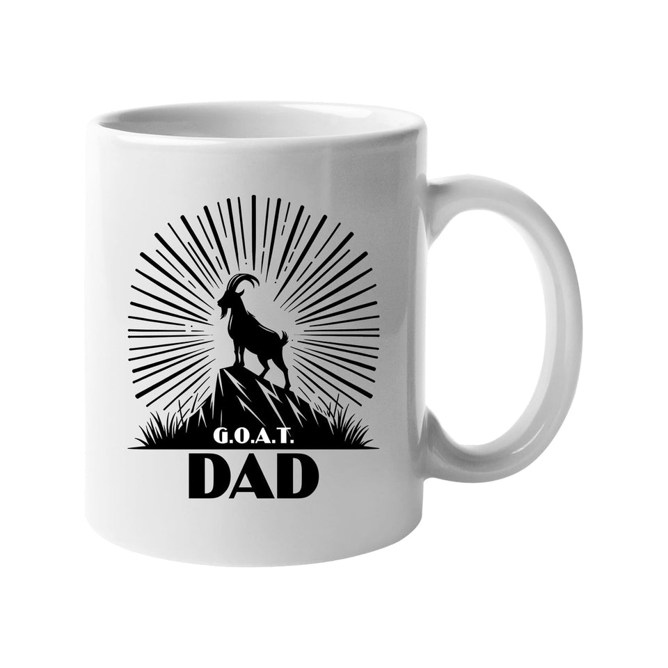 White mug with a mountain goat on a peak with a sunburst and “G.O.A.T. Dad”