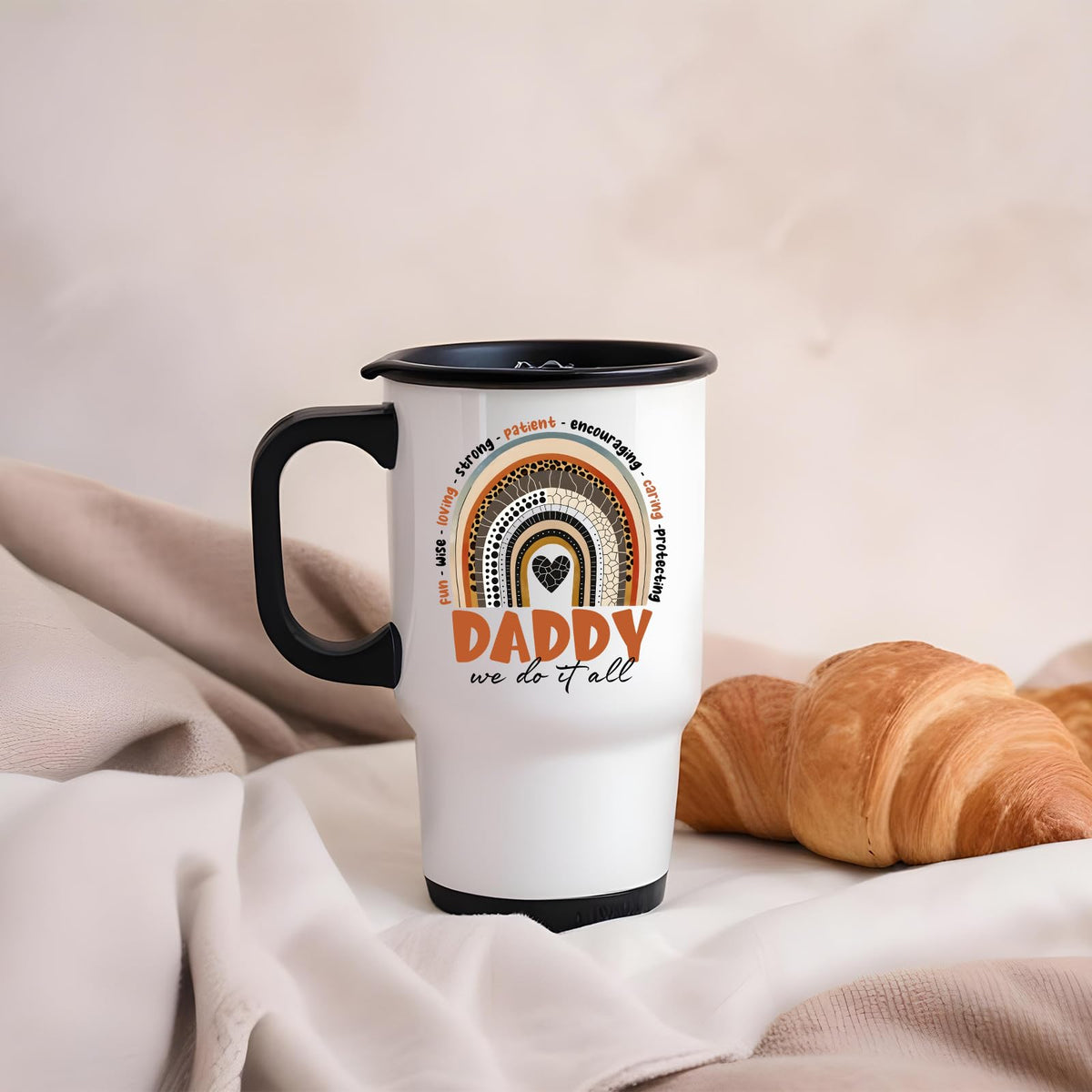 Daddy boho rainbow travel mug on a soft blanket beside a croissant