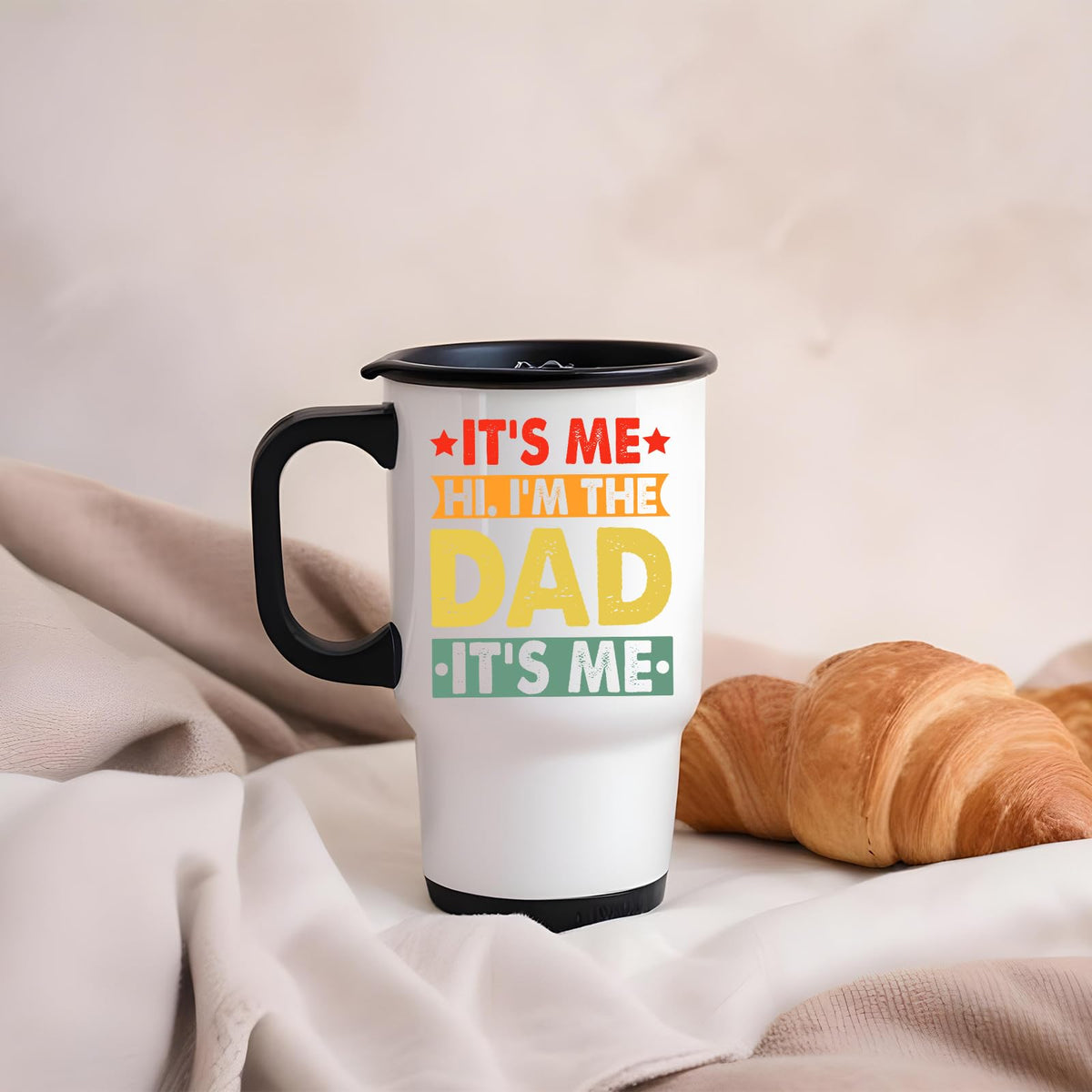 It’s Me Hi I’m the Dad travel mug on a soft blanket beside a croissant