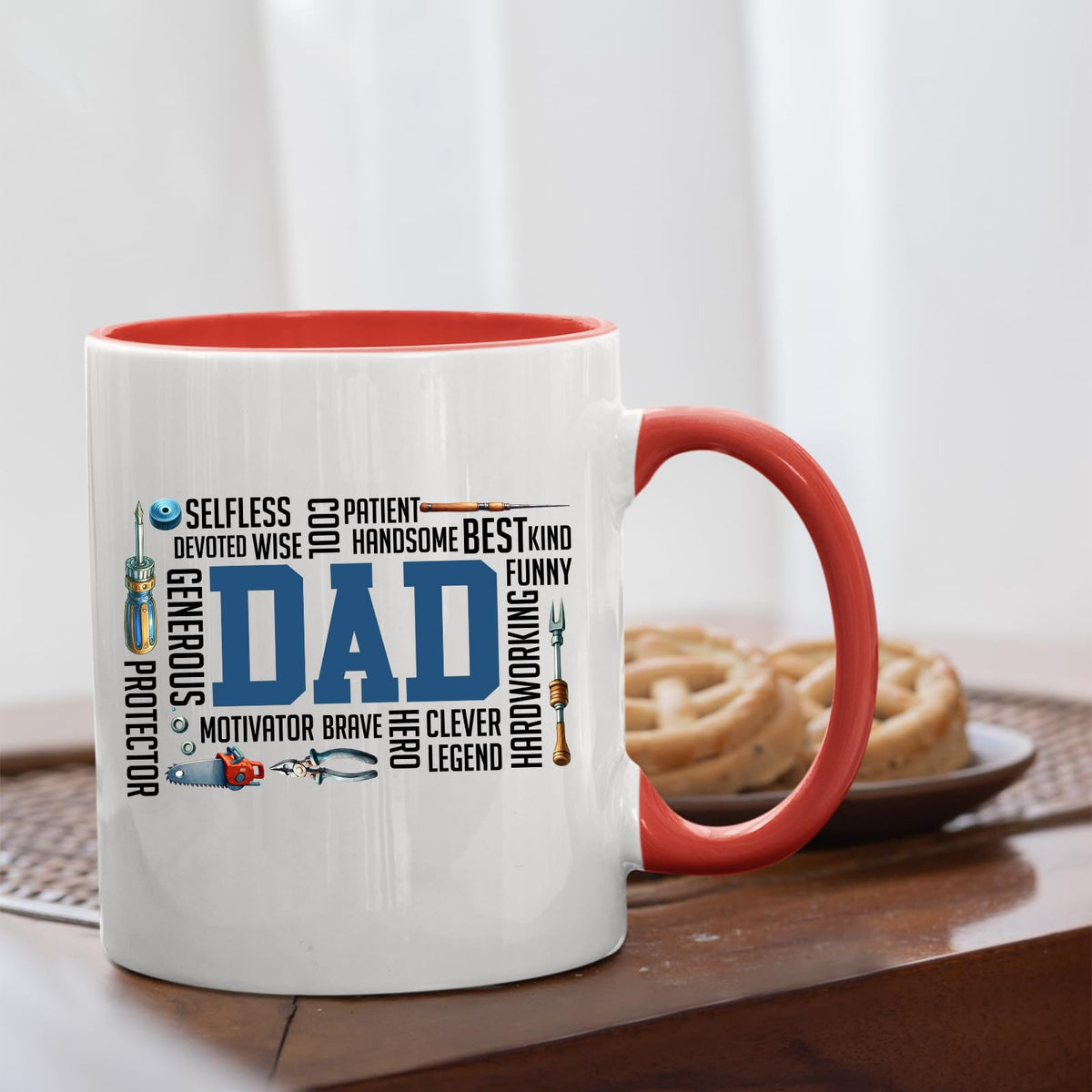 DAD word cloud mug with a red handle beside biscuits
