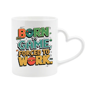 White heart-handle mug with “Born to game, forced to work” in colourful arcade lettering