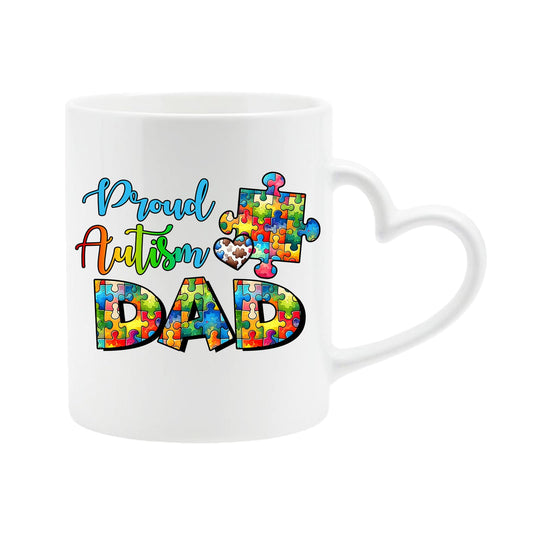 White heart-handle mug with “Proud Autism Dad” with letters filled with colourful puzzle pieces