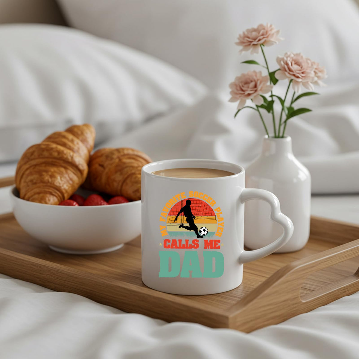 Soccer Dad heart-handle mug on a breakfast tray with croissants and flowers