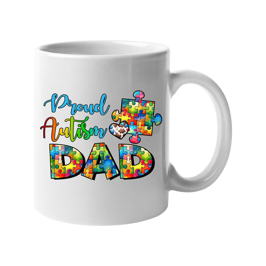 White mug with “Proud Autism Dad” with letters filled with colourful puzzle pieces