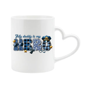 White heart-handle mug with “My daddy is my hero” in blue plaid and leopard letters with a police cap and badge