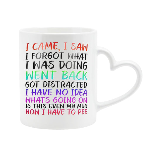 White heart-handle mug with “I came, I saw, I forgot what I was doing… is this even my mug, now I have to pee” in colourful lettering