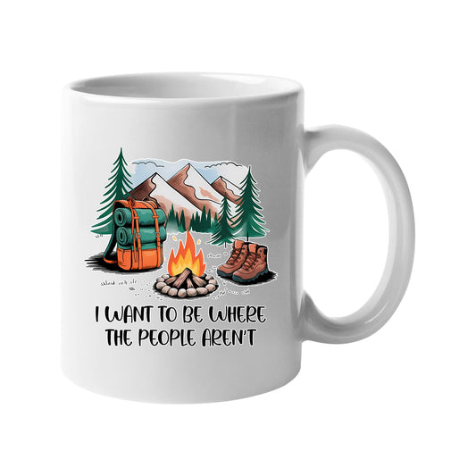 White mug with a campfire, backpack, boots and mountains with “I want to be where the people aren’t”