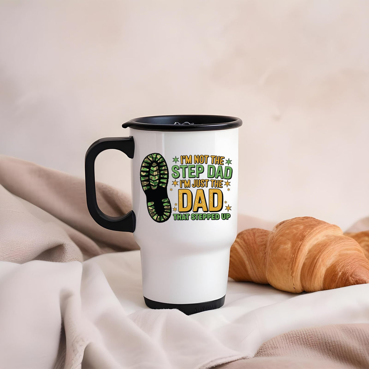 Dad That Stepped Up travel mug on a soft blanket beside a croissant