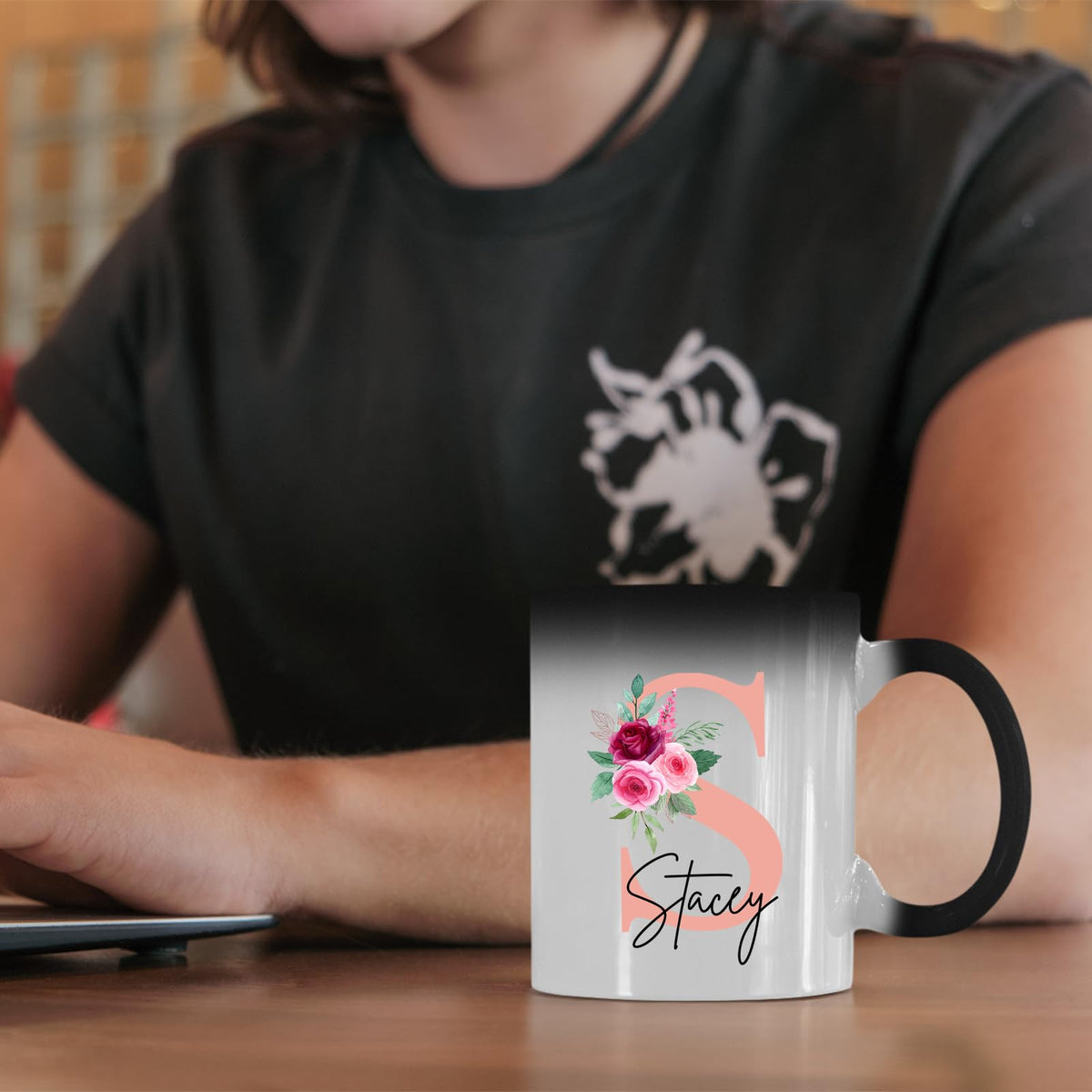 Colour changing mug with a blush pink initial with roses and an example name on a desk