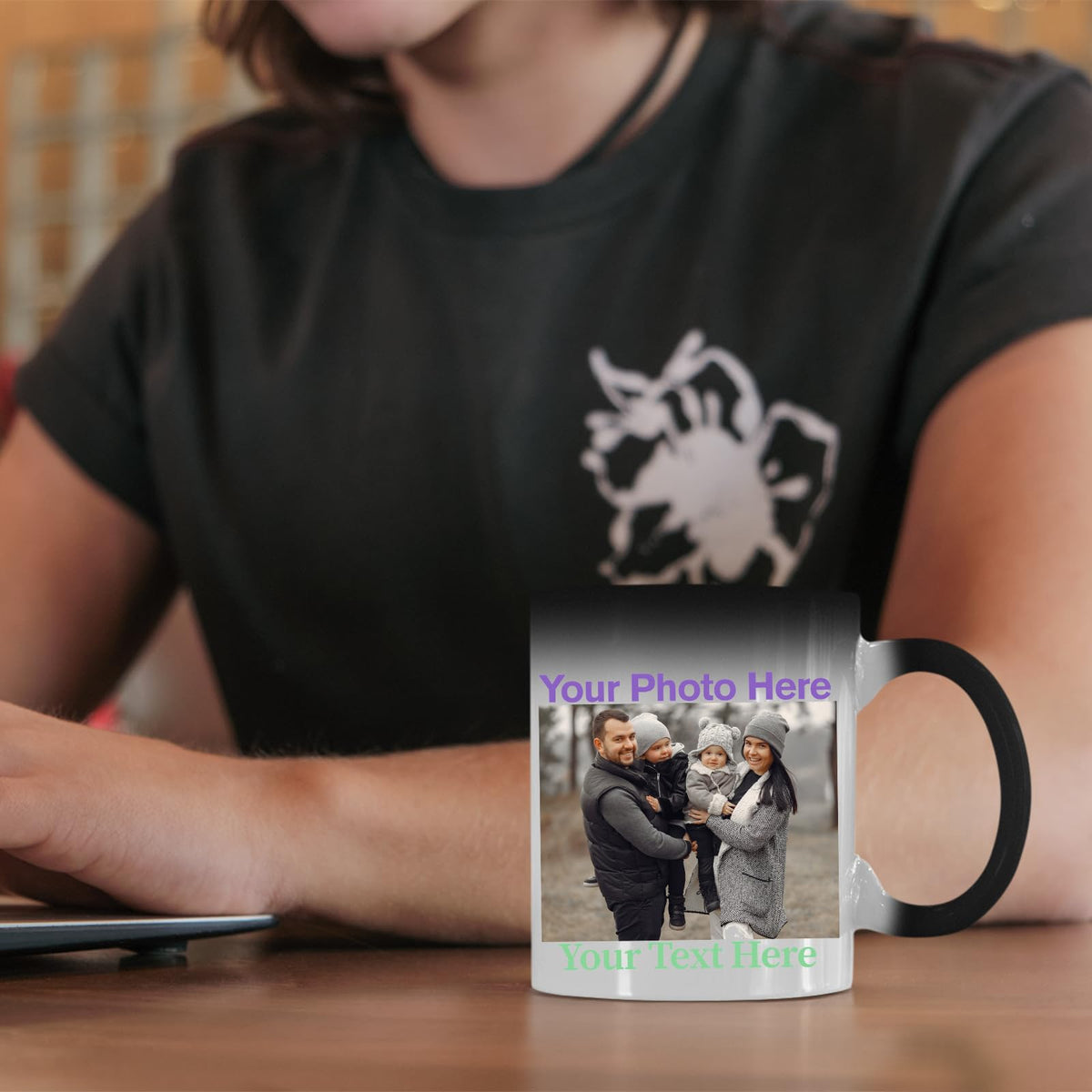 Colour changing mug with an example family photo and text on a desk
