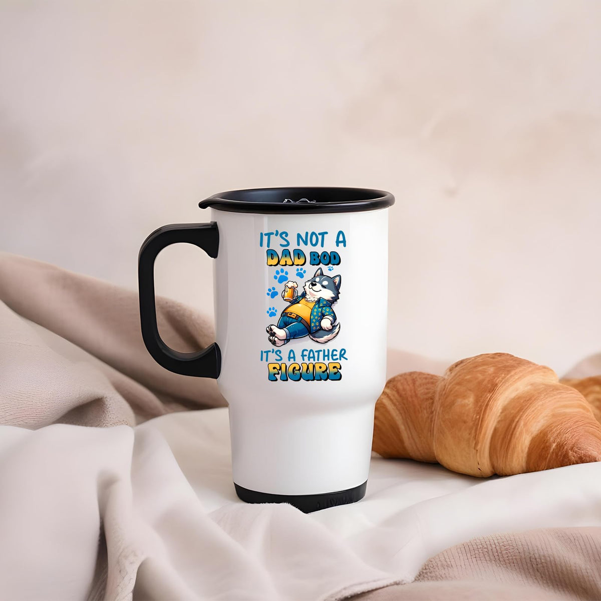 Dad Bod husky travel mug on a soft blanket beside a croissant