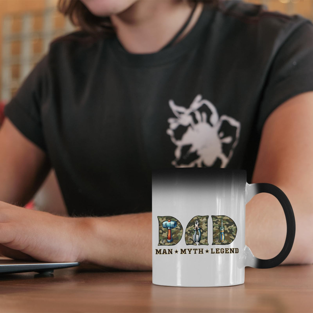 Dad Man Myth Legend tools colour changing mug on a desk beside a laptop