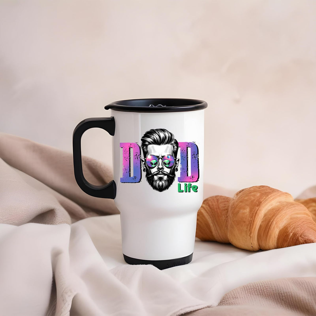 Dad Life bearded dad travel mug on a soft blanket beside a croissant