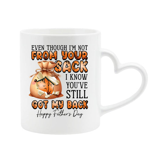 White heart-handle mug with a cartoon sack and “Even though I’m not from your sack, I know you’ve still got my back”