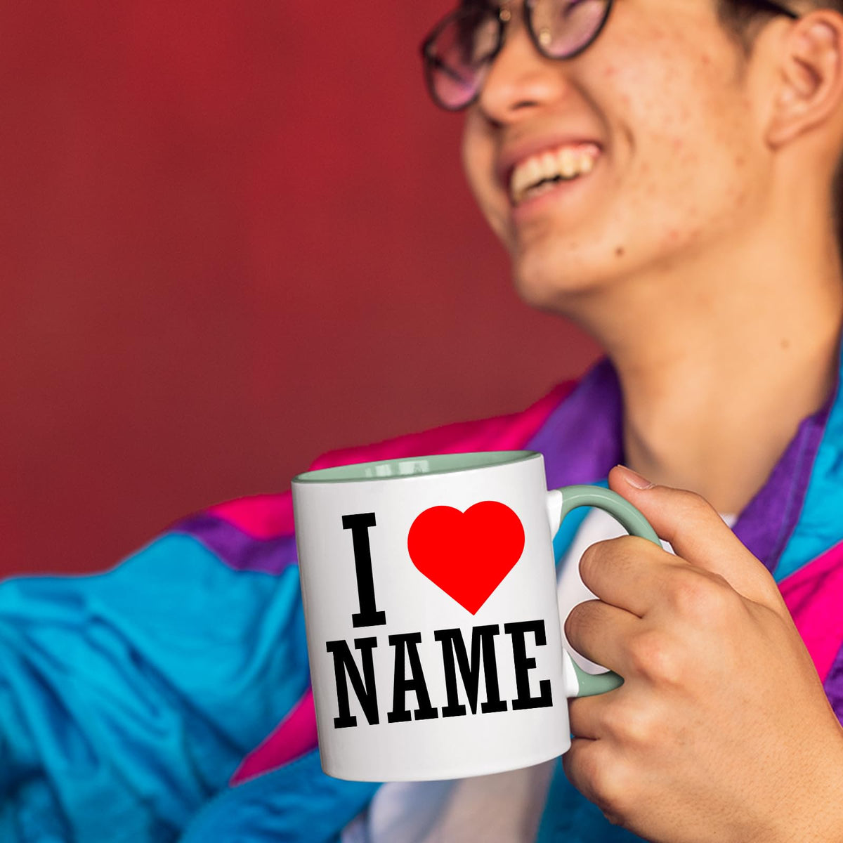 Person laughing while holding an I love name mug with a lime handle