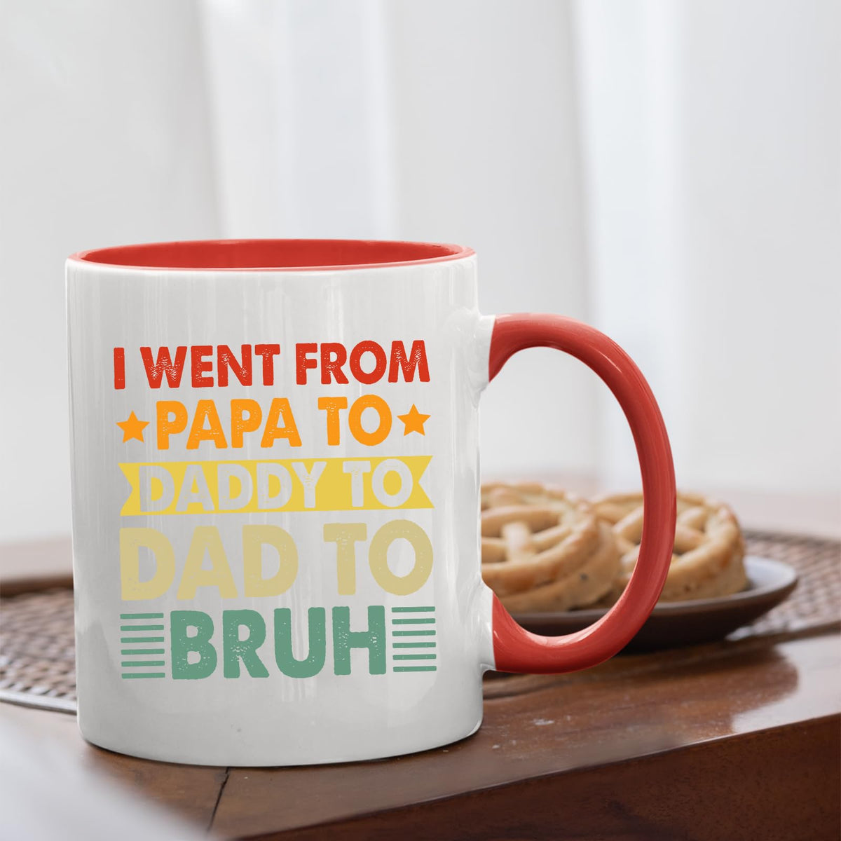 Papa to Bruh mug with a red handle beside biscuits