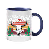 Colour handle mug with a bull skull, cacti and a retro desert sunset with “The Cool Dad” – dark blue handle and inside