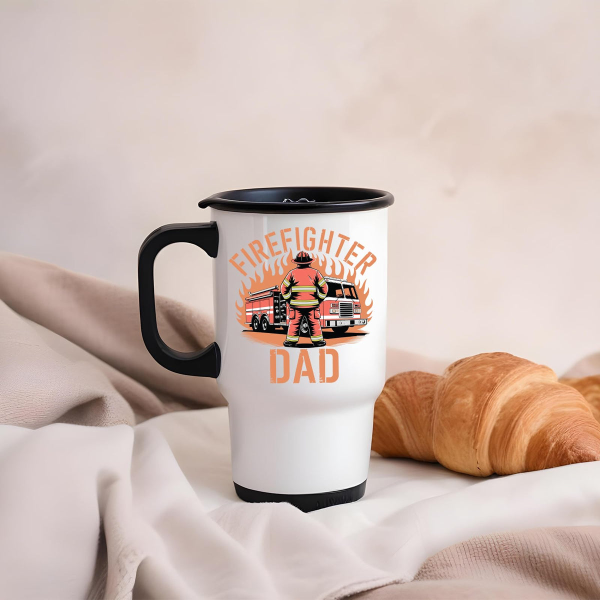 Firefighter Dad travel mug on a soft blanket beside a croissant