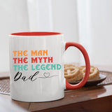 The Man the Myth Dad mug with a red handle beside biscuits