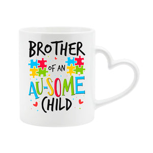 White heart-handle mug with “Brother of an AU-SOME child” with colourful puzzle pieces