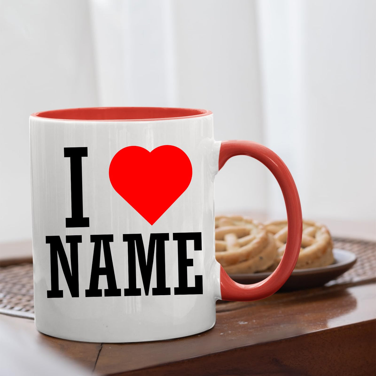 I love name mug with a red handle on a table