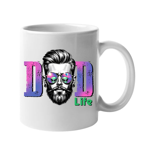 White mug with a bearded dad in sunglasses between pink “DAD” letters signed “Life”