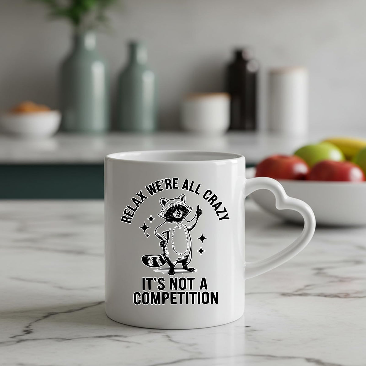 Relax We’re All Crazy raccoon heart-handle mug on a marble counter with fruit