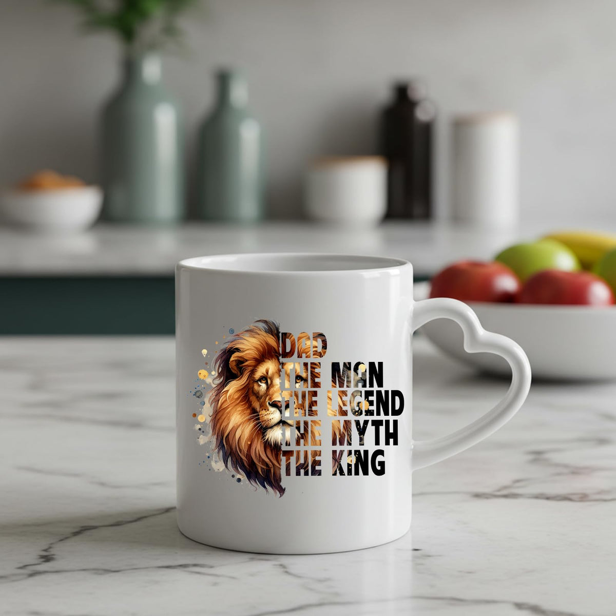 Dad the King lion heart-handle mug on a marble counter with fruit