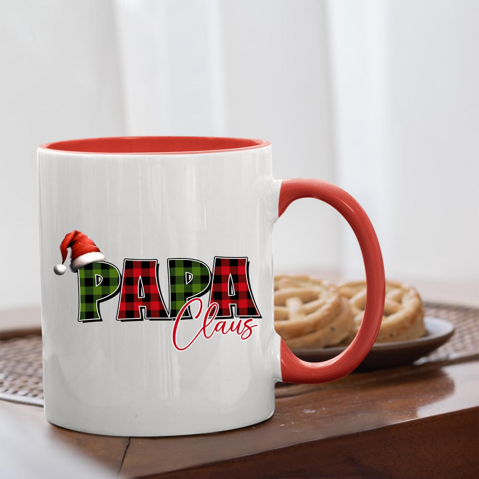 Papa Claus mug with a red handle beside biscuits