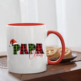 Papa Claus mug with a red handle beside biscuits